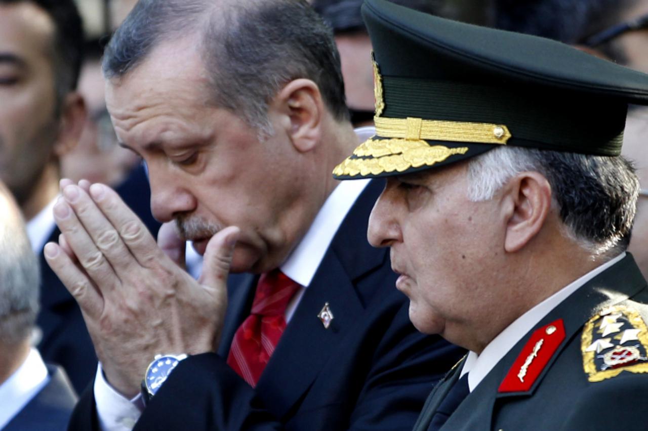 'Turkey\'s Prime Minister Tayyip Erdogan (C) and Chief of Staff General Necdet Ozel (R) attend a funeral ceremony of Turkish pilot Lt. Hasan Huseyin Aksoy, in Istanbul, on July 6, 2012. Turkish Prime 