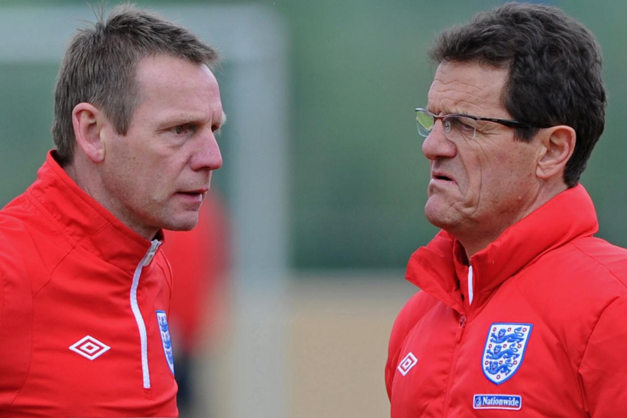 '(FILES) In a file picture taken on May 19, 2010 England football coach Fabio Capello (R) and his assistant Stuart Pearce (L) attend a team training session in Irdning, Austria ahead of the World Cup 