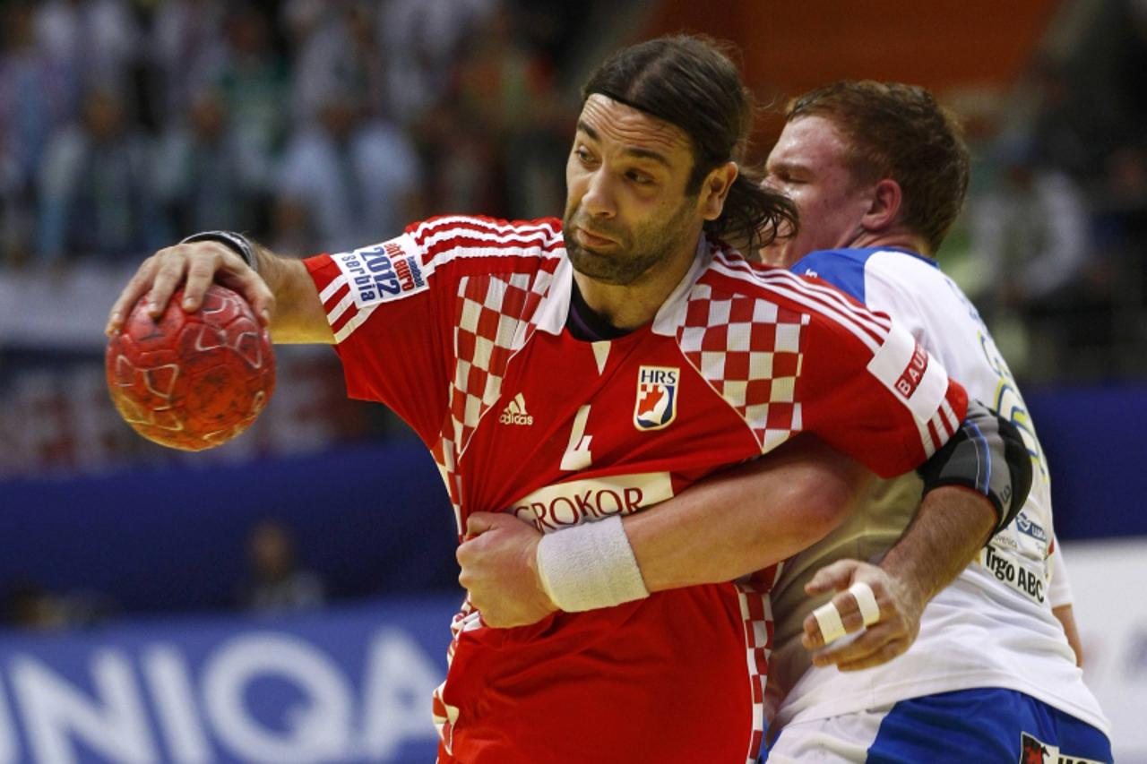 \'Croatia\'s Ivano Balic (L) challenges Slovenia\'s Matej Gaber during their Men\'s European Handball Championship Group D match in Vrsac January 18, 2012.         REUTERS/Ivan Milutinovic (SERBIA  - 