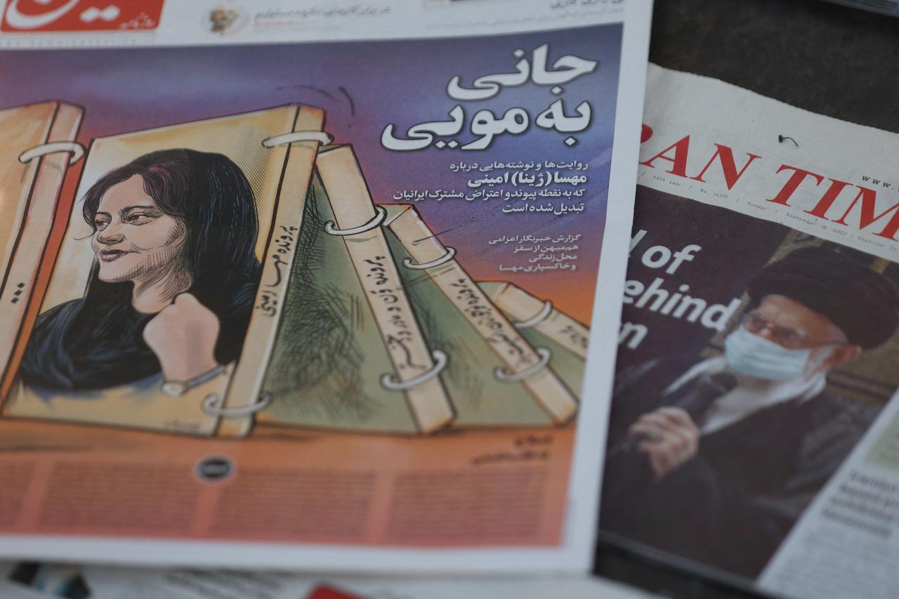 Newspapers with Amini, a victim of country's "morality police", are seen in Tehran