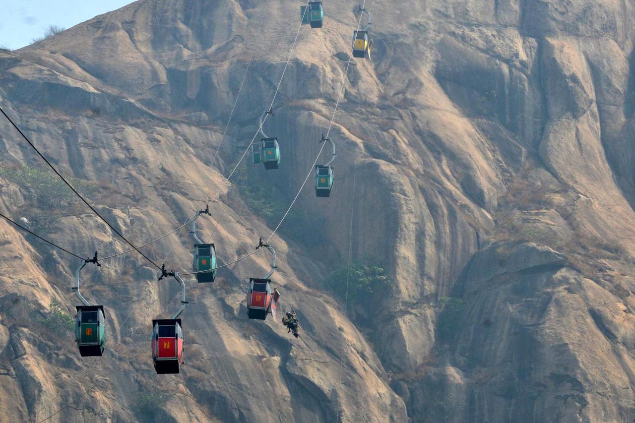 Indian Air Force personnel carry out rescue mission mid-air after Sunday's cable-car collision in Deoghar