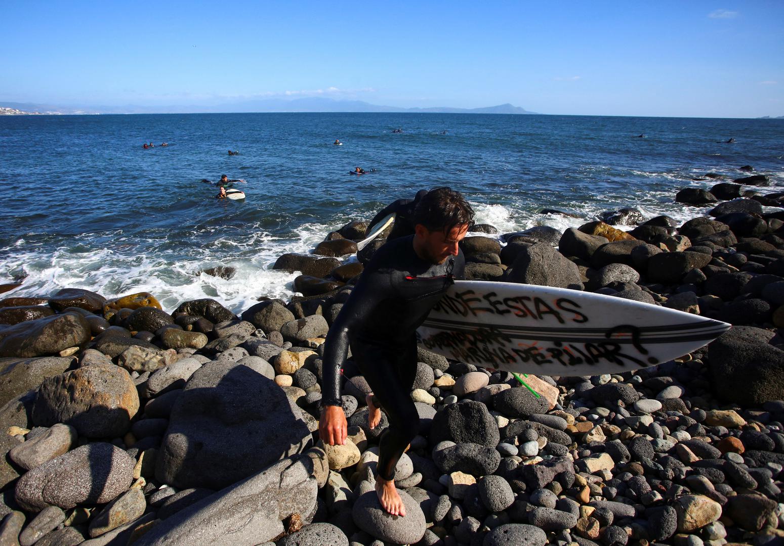 A local surfer leaves as he takes part in a demonstration calling for the authorities to solve the disappearances of U.S. and Australian surfers in Ensenada after Mexican authorities said the parents of the missing tourists arrived in Mexico to try to identify the dead bodies believed to be their children, in Ensenada, Mexico May 5, 2024. REUTERS/Jorge Duenes Photo: JORGE DUENES/REUTERS