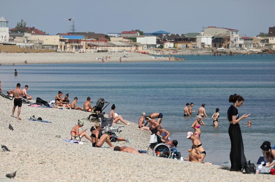 People sunbathe at the beach in Yevpatoriya