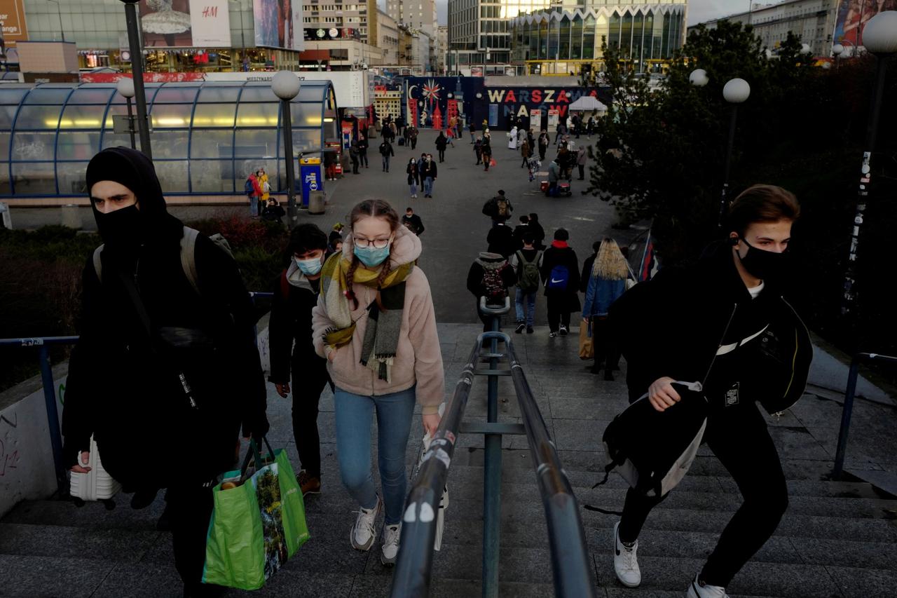 FILE PHOTO: People wearing protective masks amid the outbreak of coronavirus disease (COVID-19) walk in centre of Warsaw