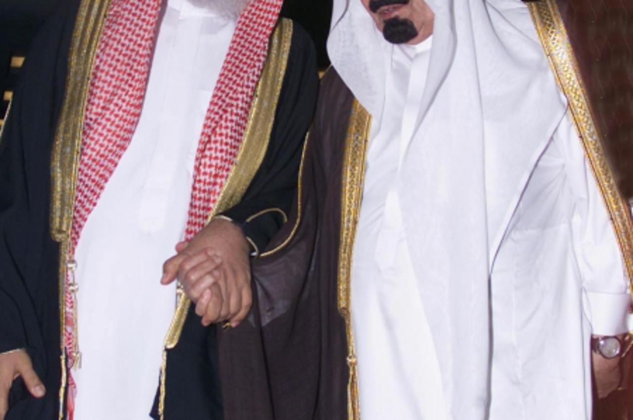 \'Saudi Crown Prince Abdullah bin Abdul Aziz (R) holds the hand of the kingdom\'s Grand Mufti Sheikh Abdul Aziz al-Shaikh at the opening of the first ever forum for Saudi charitable organizations. The