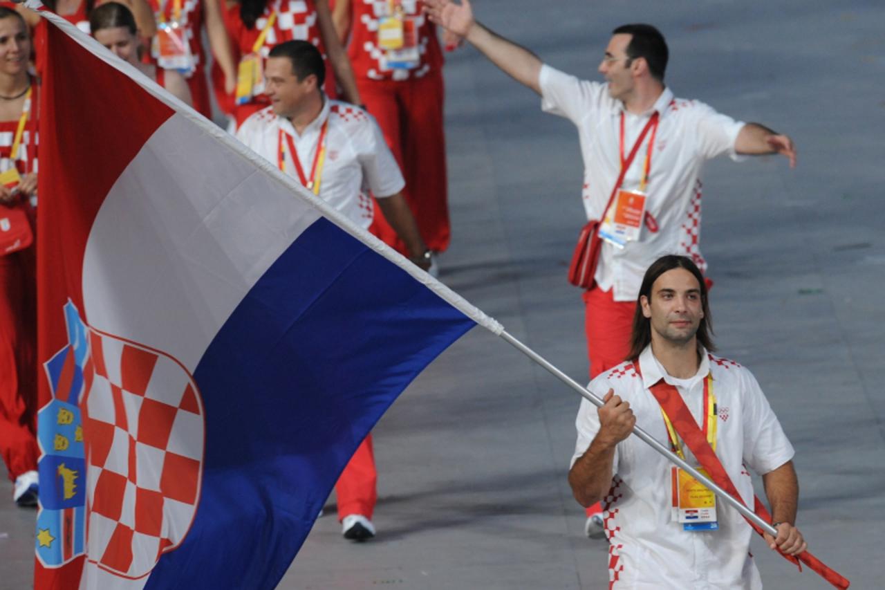 'Ivano Balic Croatia\'s flag bearer parades in front of his delegation during the 2008 Beijing Olympic Games opening ceremony on August 8, 2008 at the National Stadium in Beijing.  Over 10,000 athlete