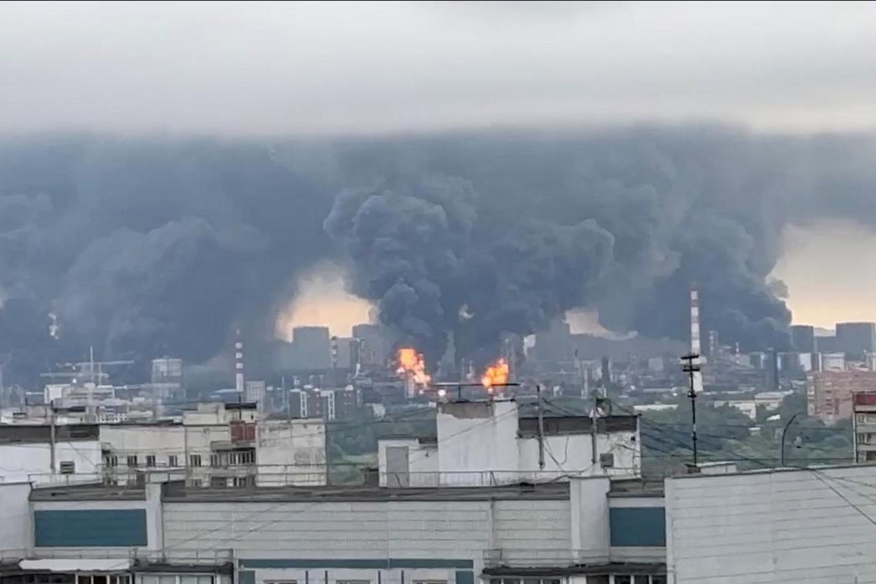Thick plumes of smoke with flames rise from an oil refinery in Moscow