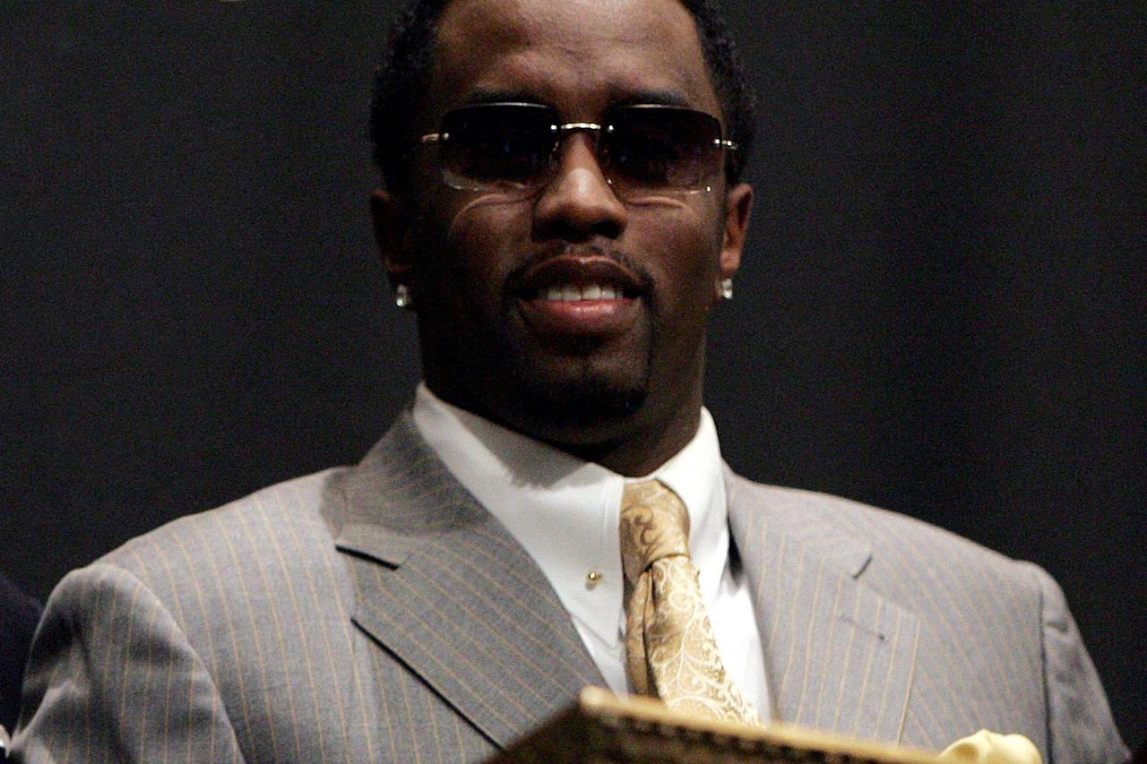 FILE PHOTO: Sean "Diddy" Combs poses for pictures on a balcony of the New York Stock Exchange in New York