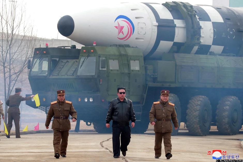 North Korean leader Kim Jong Un walks away from a missile