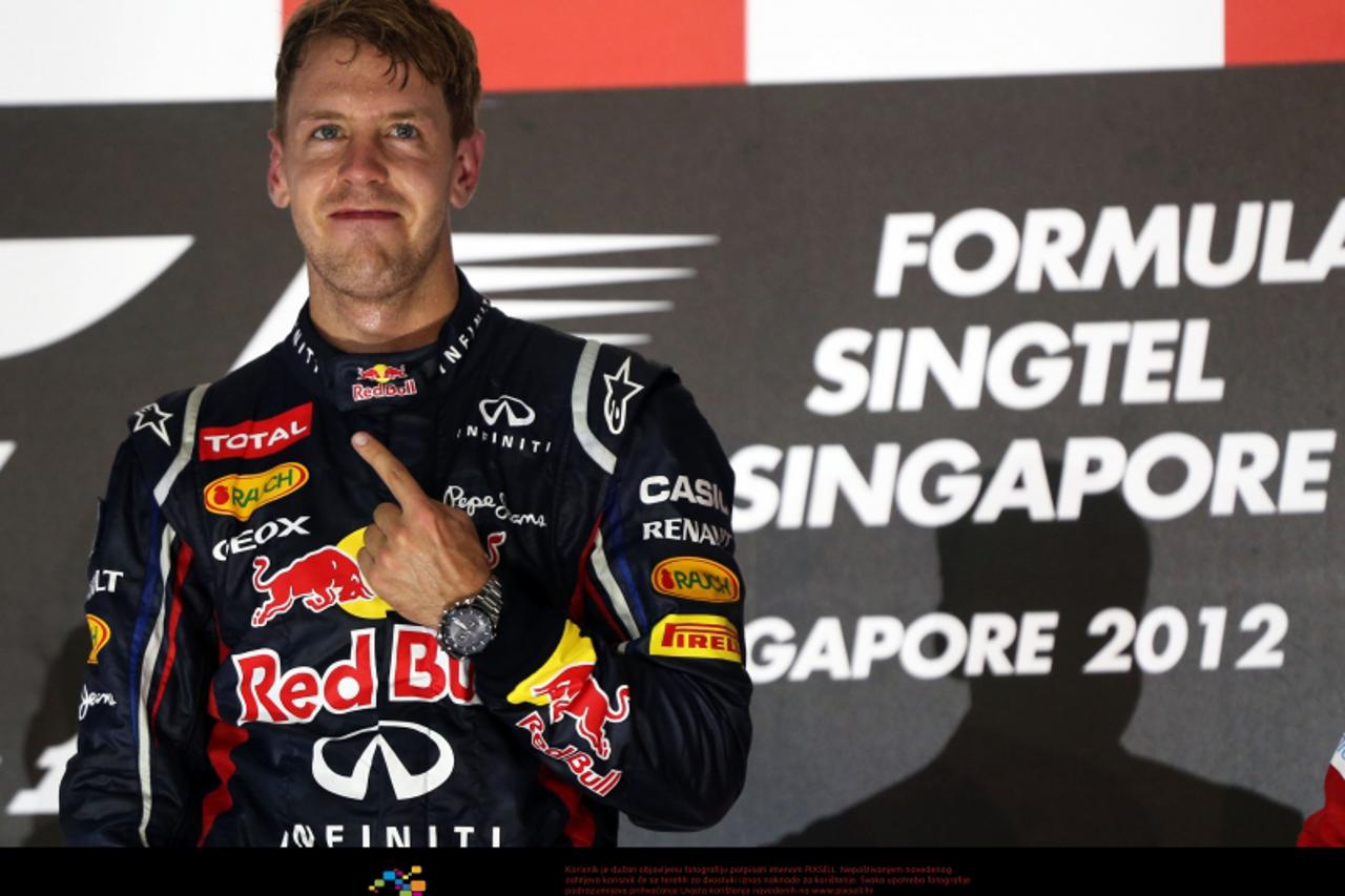 'German Formula One driver Sebastian Vettel of Red Bull celebrates on the podium after winning the Formula One Grand Prix of Singapore at the race track Marina-Bay-Street-Circuit, Singapore, 23 Septem
