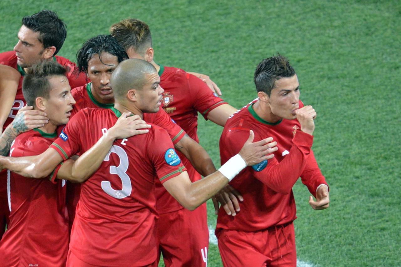'Portuguese forward Cristiano Ronaldo (R) celebrates with teammates after scoring during the Euro 2012 football championships match Portugal vs. Netherlands, on June 17, 2012 at the Metalist stadium i